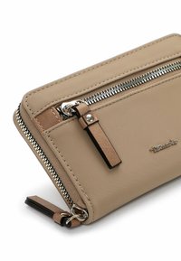 Beige fabric wallet with silver zipper detail, rectangular shape, textured surface, and leather accents. Features a logo on the front.