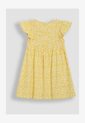 Geltona medvilnės suknelė su balta gėlių spausdintine medžiaga, trumpomis šoninėmis raukinėmis, apvaliu iškirpimu ir surinkta sijonu. Mygtukų uždarymas nugarinėje pusėje.