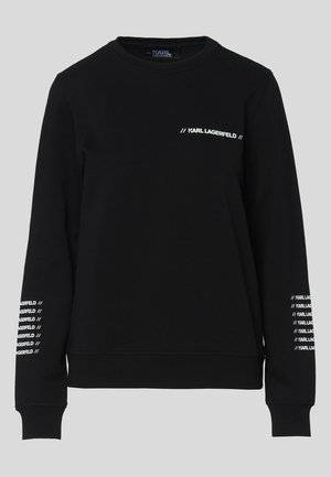 Sweat-shirt noir en tissu doux, avec manches longues, encolure ronde et logo blanc imprimé sur la poitrine et les manches.