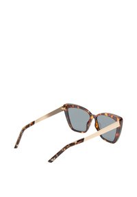 Okulary przeciwsłoneczne w stylu kocich oczu z motywem żółwim, szarymi soczewkami i złotymi metalowymi akcentami na zausznikach. Odważny, geometryczny design.