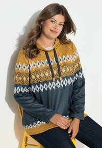 Felpa con cappuccio in senape e blu navy con motivo geometrico bianco. Tessuto morbido e vestibilità rilassata; presenta un cordoncino e maniche lunghe.