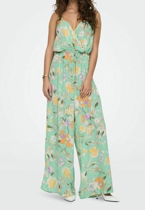 Floral jumpsuit in mint green with a V-neckline, cinched waist, and wide-leg design featuring orange, purple, and yellow patterns. Smooth fabric.