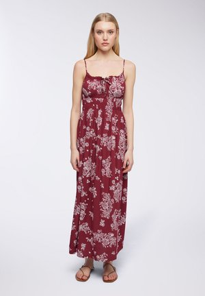 Abito maxi in tessuto bordeaux, con stampa floreale bianca, spalline regolabili, scollatura arricciata e vita arricciata per una silhouette fluida.