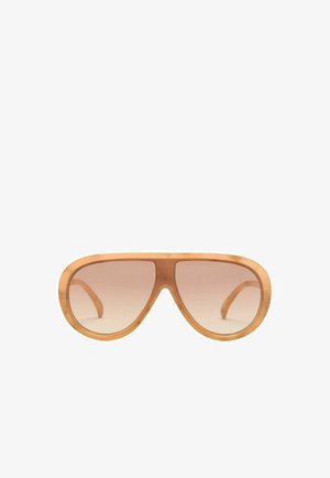 Lunettes de soleil avec une grande monture en bois arrondie et des verres marron dégradés, présentées de face sur un fond blanc.