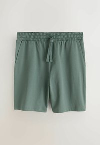Zielone bawełniane spodenki z elastycznym paskiem i sznurkiem do regulacji, wyposażone w dwie boczne kieszenie i miękką, gładką fakturę.
