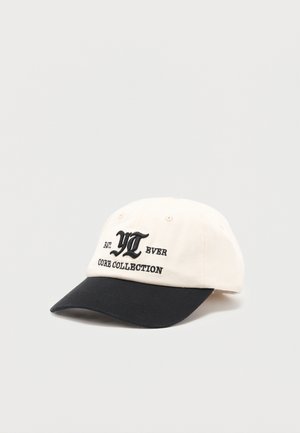 White and black baseball cap with black embroidered text "YI EVER CORE COLLECTION" on the front panel against a plain background.