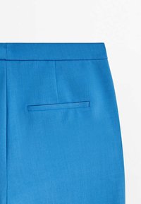 Bright blue trousers feature a smooth fabric, tailored design, and a single back pocket with a clean finish.