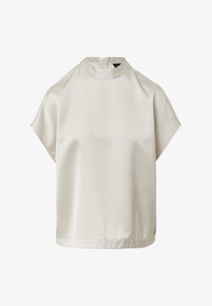 Korte mouwen, hooggesloten top van lichtbeige stof. Gladde textuur met een ritssluiting aan de achterkant en subtiele merkdetails aan de zoom.