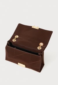 Borsa in pelle marrone con una forma strutturata, dotata di accentuazioni dorate e un flap pieghevole. Internamente ha una fodera nera e una tasca con zip.