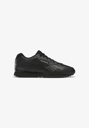 Black athletic shoes made of leather with textured surface, featuring a lace-up design, rubber sole, and a subtle Reebok logo on the side.
