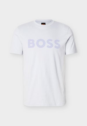 Valge puuvillane t-särk, millel on suurelt esiküljel helelilla "BOSS" trükk. Klassikalise ümara kaelusega ja lühikeste varrukatega. Puhas disain.