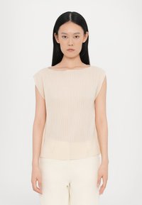 Light beige sleeveless top made of textured fabric with subtle vertical stripes; features a wide neckline and straight hem.