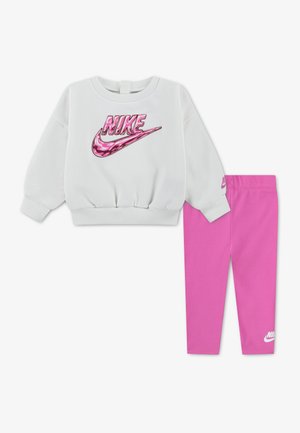 Λευκό φούτερ Nike με μακριά μανίκια και ροζ καμουφλάζ λογότυπο, με αντίστοιχα μονόχρωμα ροζ κολάν Nike για παιδιά.