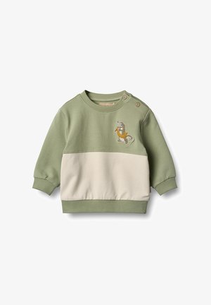 Tricou cu blochează de culori verde și crem, cu guler rotund, mâneci lungi și țesătură texturată; are un design brodat cu un dinozaur.