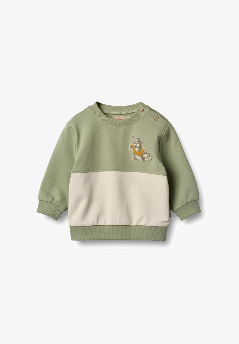 Felpa color block verde e crema con scollatura rotonda, maniche lunghe e tessuto testurizzato; presenta un design di dinosauro ricamato.