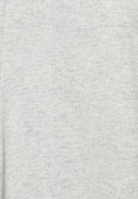 Tissu tricoté gris clair à la texture douce, présentant un motif chiné subtil. Le matériau semble lisse et léger.