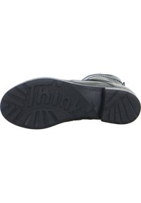 Schwarze Gummistiefelsohle mit tiefen Profil und "Think"-Logo. Verfügt über strukturierte Details und eine verstärkte Ferse für besseren Halt und Langlebigkeit.