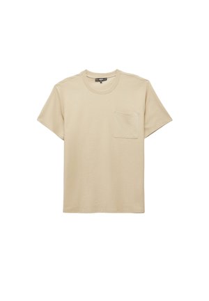 Camiseta de manga corta beige hecha de algodón suave, con un escote redondo y un bolsillo en el pecho del lado izquierdo. Textura suave.