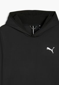 Sweat à capuche noir avec doublure texturée, présentant un logo blanc, un tirette de fermeture éclair circulaire et un détail intérieur contrastant.