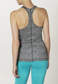 Top senza maniche con motivo in bianco e nero, design con schiena a corsetto, realizzato in materiale leggero. Abbinato a leggings turchesi uni.