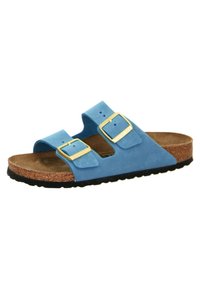 Blue suede sandals with two gold buckles, cork footbed, and a black rubber sole. Open design for breathability and comfort.