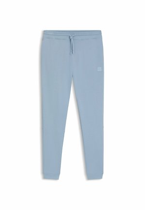 Pantaloni jogger azzurri chiari realizzati in tessuto morbido. Presentano una vita con cordino, vestibilità slim e una piccola etichetta logo sulla coscia sinistra.
