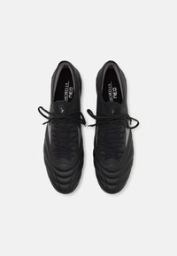Black soccer cleats with a textured leather upper and padded collar. Features flat laces and a logo on the tongue.