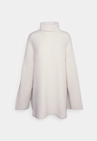 Oversized crèmekleurige gebreide trui met een hoge col, brede mouwen en een textuur met geribbelde patronen. Zacht materiaal, ontspannen pasvorm en zijsplitten.
