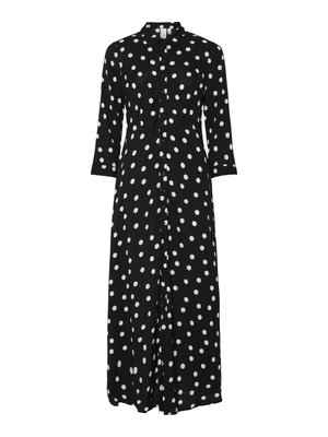 Zwarte button-up jurk met driekwart mouwen. Kenmerkt zich door grote witte polka dots, een kraag en een taille-inzet. Vloeiende stof valt elegant.