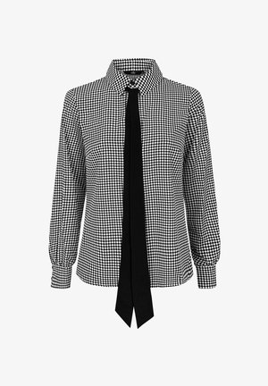 Czarno-biała, w kratę bluzka z długim rękawem, z szpiczastym kołnierzykiem i solidnym czarnym paskiem w pionie na przodzie.