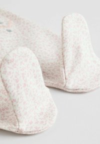Floral-patterned fabric booties in soft pink and white, featuring rounded edges and stitched seams for durability and comfort.