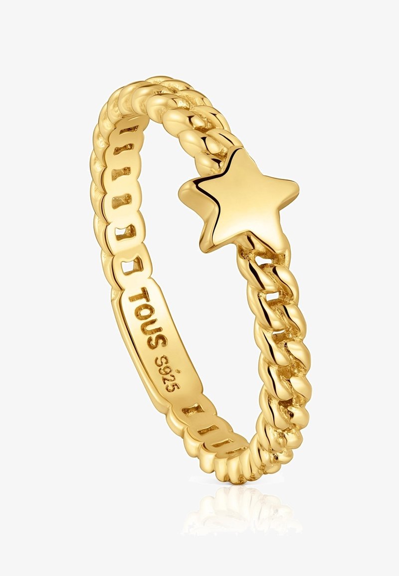 Anello in oro con band spirale caratterizzato da un accento a forma di stella lucida. Inciso "TOUS S925" sulla superficie interna, che mette in mostra una finitura liscia e lucida.