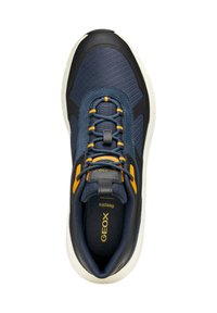 Zapatilla azul marino con parte superior de tejido texturizado, acentos en naranja y talón negro. Presenta un sistema de cordones y una suela acolchada para mayor comodidad.