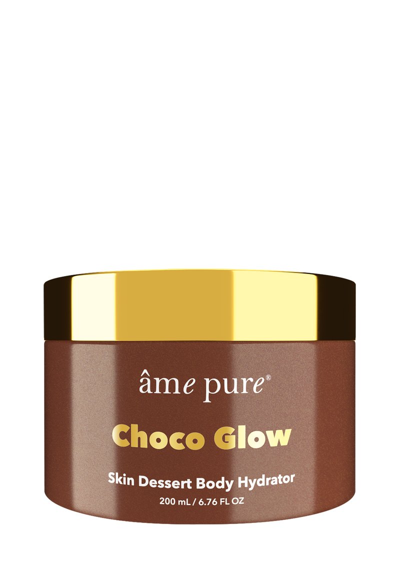 Brun burk med ett guldlock. Etiketten visar "Choco Glow Skin Dessert Body Hydrator, 200 mL." Slät textur, modern design, minimala grafik.