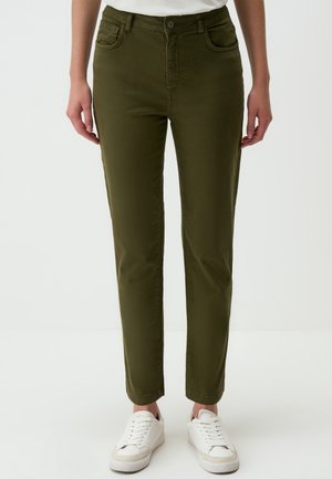 Olive green, slim-fit pants made of soft fabric with five pockets, a button closure, and a smooth texture, paired with white sneakers.