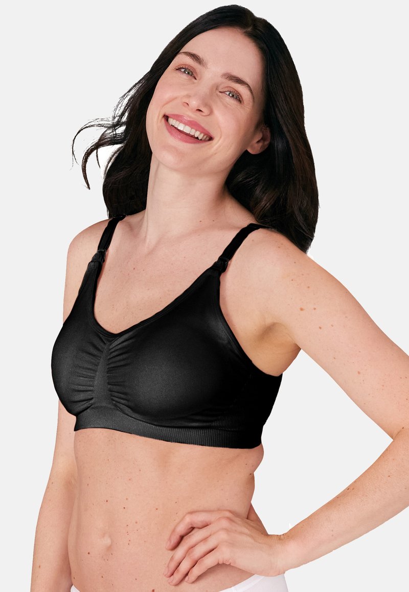 Schwarzer kabelloser BH mit gerafftem Vorderteil, glatter Textur, verstellbaren Trägern und minimalistischer Gestaltung. Keine sichtbaren Beschläge oder Muster.