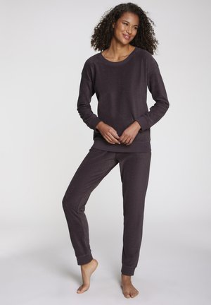 Dark purple loungewear set featuring a relaxed-fit sweatshirt with long sleeves and matching tapered pants with elastic cuffs and soft texture.