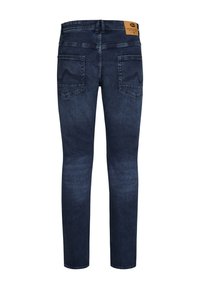 Tummansinisiä farkkuja slim fit -mallilla. Omistaa kaksi takataskua, erivärisiä ompeleita ja vaaleanruskean nahkapatchin vyötäröllä.