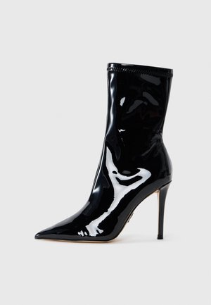 Black patent leather ankle boot with a pointed toe and a thin, high heel. Features a smooth, glossy finish and a stitched cuff detail.