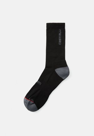 Schwarze Sportsocke mit grauem Zeh und Ferse. Verfügt über eine gerippte Textur und einen grauen Logo-Druck. Größe L-XL wird auf der Zehe angegeben.