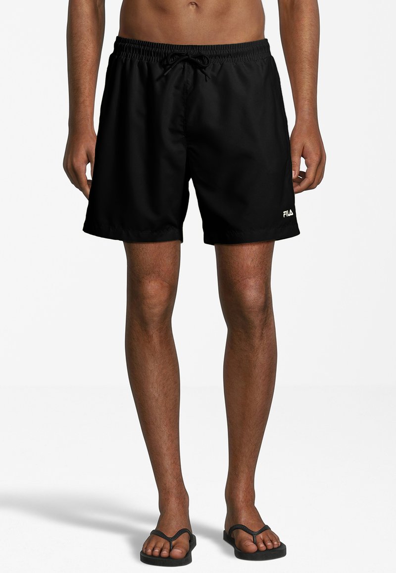 Pantaloni da bagno neri realizzati in materiale leggero, con un cinturino elastico dotato di cordino e un piccolo logo bianco sull'orlo sinistro.