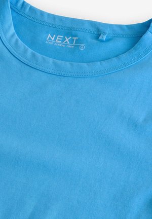 Lange mouw crew t-shirt in effen lichtblauwe katoen. Bevat een ronde halslijn en eenvoudige stiksels. Etiket luidt "NEXT," maat S.