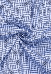 Blauwe stof met een geometrisch patroon van hexagonen en cirkels, met verschillende tinten blauw en wit, gladde textuur.