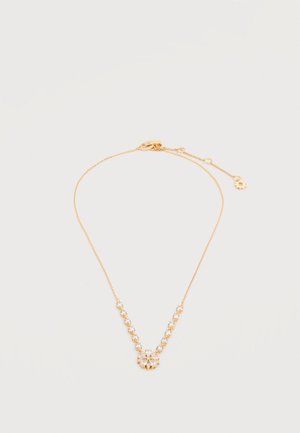 Delicate gouden ketting met doorzichtige edelsteenaccenten die een V-vorm vormen en een bloemvormige hanger bij de sluiting, afgebeeld op een witte achtergrond.