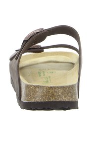 Brown suede sandal with a wide strap and decorative floral accents. Soft footbed, cork sole, and a contoured shape for comfort.