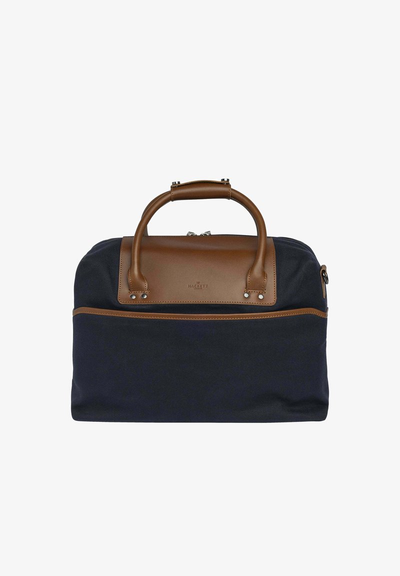Námorně modrá plátěná taška s hnědými koženými detaily, vybavená horním uchem a přední kapsou se zipem. Hladký povrch, kompaktní tvar.