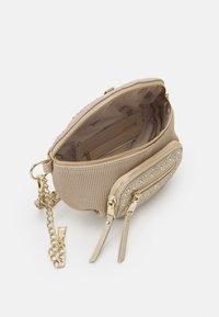 Beige textured crossbody bag with gold zippers, dual compartments, and chain strap. Interior features a zip pocket and logo lining.