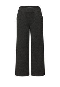 Pantalon à jambes larges noir avec une texture tachetée, doté d'une ceinture lisse et d'une coupe droite, conçu pour le confort et la liberté de mouvement.