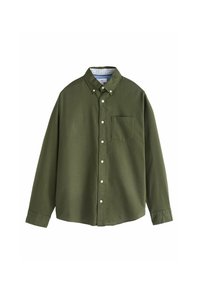 Chemise verte à manches longues en coton. Dotée d'un col, d'une poche poitrine et de boutons blancs. Texture lisse et coupe ajustée.