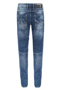Jeans aus Denim in einem mittleren Blauton, mit dekorativer Naht auf den Gesäßtaschen und einer schlanken, schmal zulaufenden Passform.